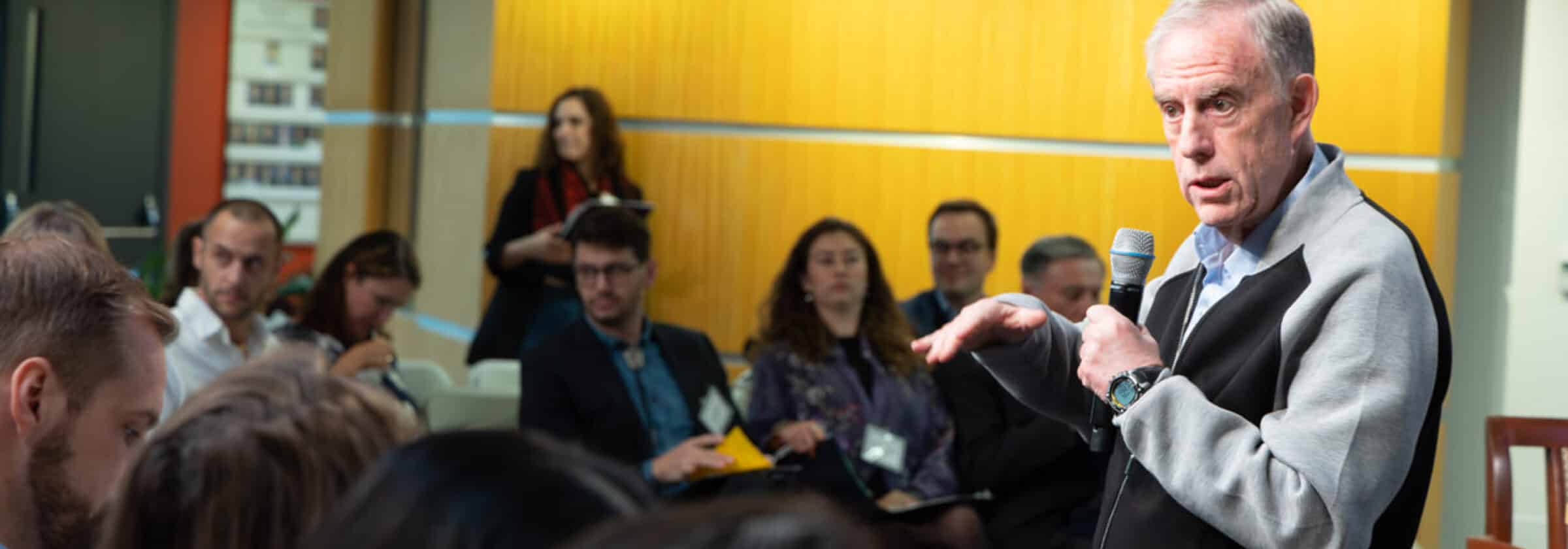 Participants take part in a workshop in a warmly lit seminar room.