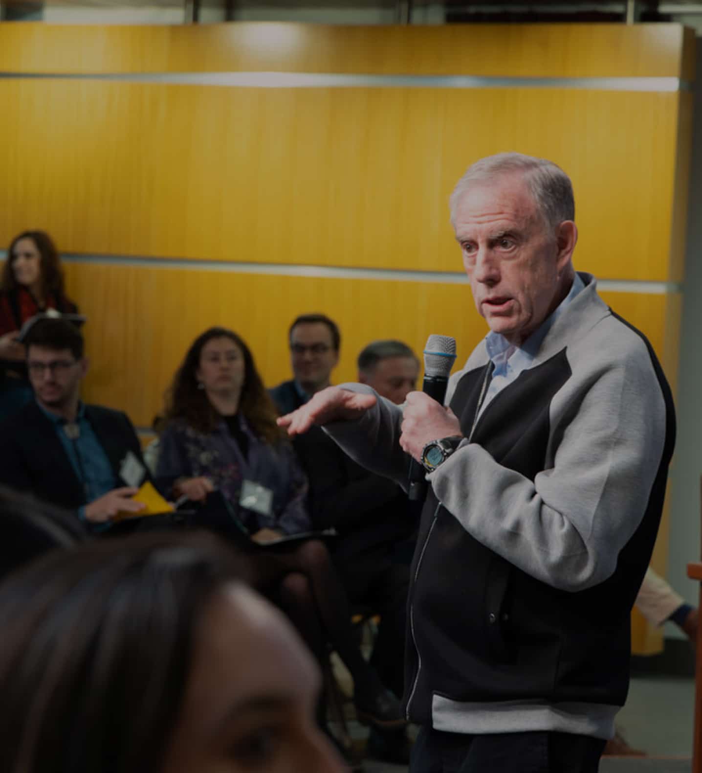A faculty member, Brian Mandell, speaks to a seated audience.