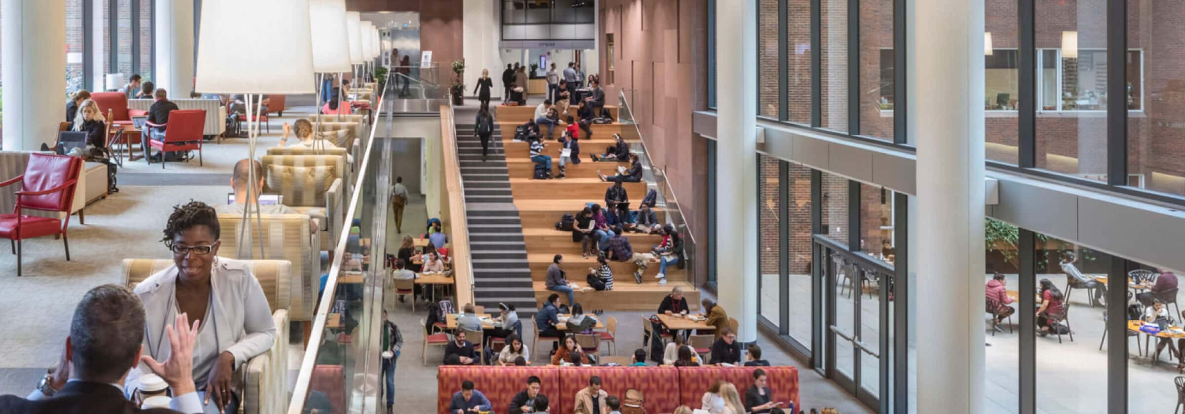 People talk on the staircase of the Sunshine Lobby of HKS.