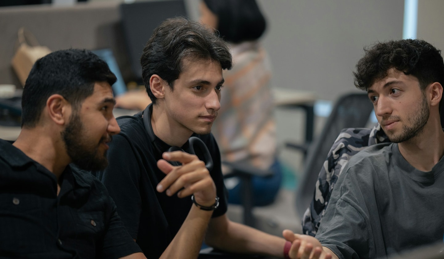 A group of students sitting next to each other talking