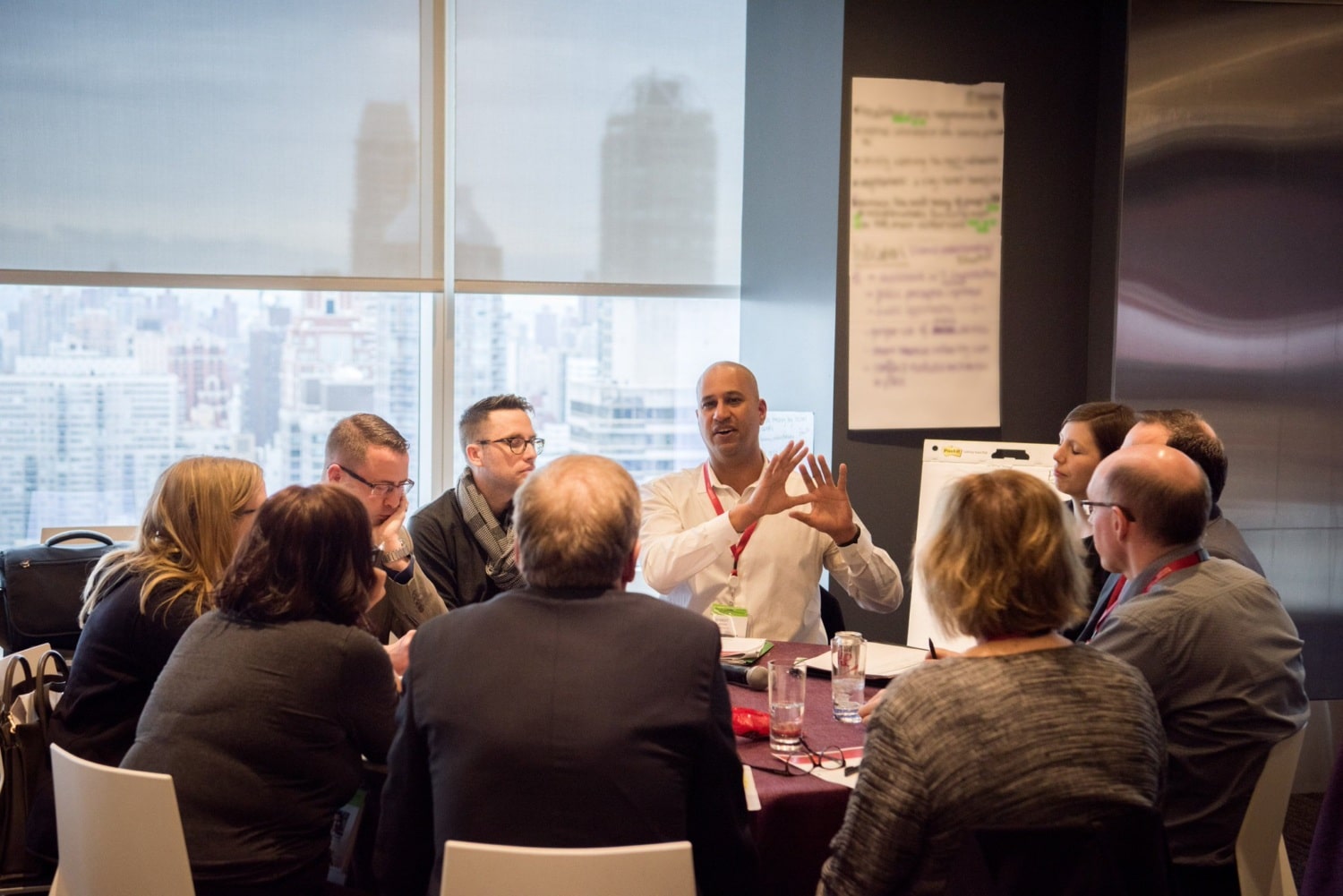 Group of city leaders sitting around a table talking