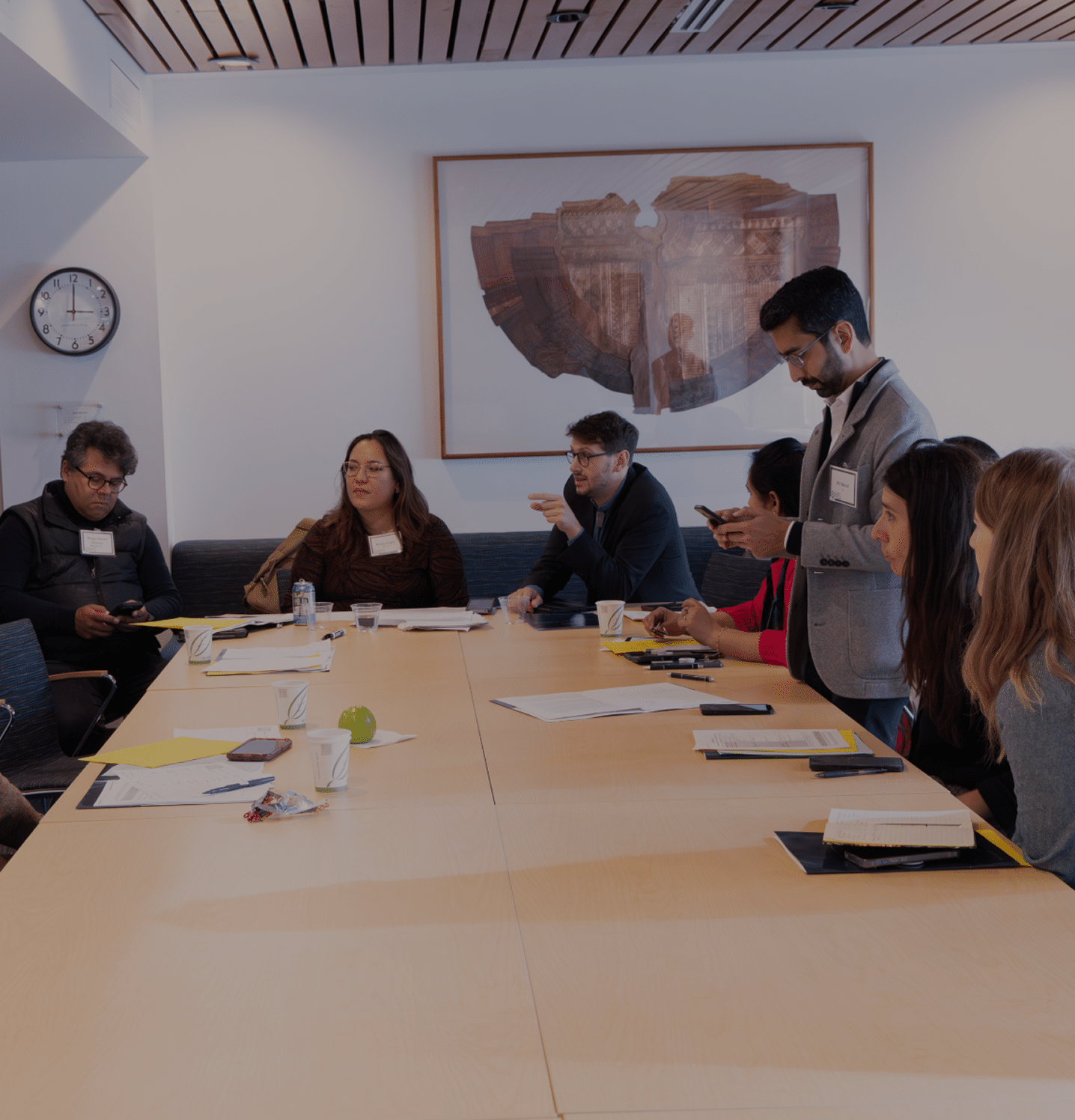 A group of participants work around a table during a Negotiation Simulation.
